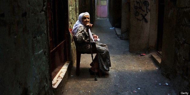 BEIRUT, LEBANON - JUNE 27: An older woman sits in a poor neighborhood with a high concentration of Syrian refugees on June 27, 2013 in Beirut, Lebanon. Currently the Lebanese government officially hosts 546,000 Syrians with an estimated additional 500,000 who have not registered with the United Nations. Lebanon, a country of only 4 million people, is now home to the largest number of Syrian refugees who have fled the conflict. The situation is beginning to put a huge social and political strains on Lebanon with no end in sight to the war in Syria. (Photo by Spencer Platt/Getty Images)