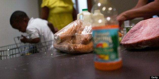NEW YORK, NY - JULY 24: A client of the West Side Campaign Against Hunger food pantry fills up a box with food on July 24,