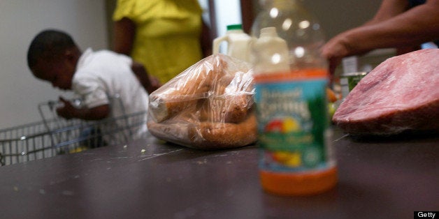 NEW YORK, NY - JULY 24: A client of the West Side Campaign Against Hunger food pantry fills up a box with food on July 24, 2013 in New York City. The food pantry assists thousands of qualifying New York residents in providing a monthly allotment of food. In an anticipated speech today in Illinois, President Obama tried to re-focus the nations attention back onto the economy and the growing inequality between the rich and the rest of America. As of May 2013 the unemployment rate in America was stuck at 7.6% with many more Americans having given up on looking for work. (Photo by Spencer Platt/Getty Images)