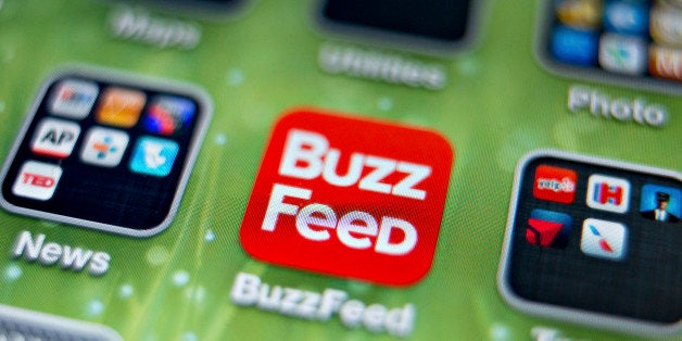 An icon for the BuzzFeed app is photographed on the home screen of an Apple Inc. iPhone 5 in Tiskilwa, Illinois, U.S., on Thursday, May 30, 2013. New York Times Co., looking to imitate the business models used by startups such as BuzzFeed Inc., is considering letting advertisers sponsor more stories on its website, two people with knowledge of the situation said. Photographer: Daniel Acker/Bloomberg via Getty Images