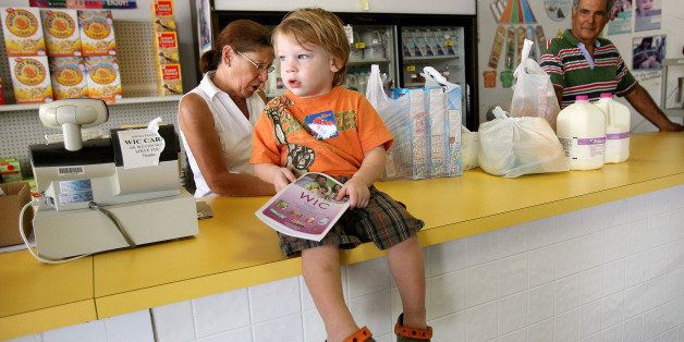 Lukas Green, 2, sits on the counter at Al's Food Store in Casselberry, Florida, October 5, 2009, while his mother shops. The store accepts WIC checks and carries fresh fruit as part of changes in the program offering fresher and healthier food. (Photo by Jacob Langston/Orlando Sentinel/MCT via Getty Images)