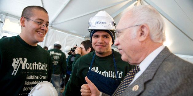 UNITED STATES - MARCH 17: Rep. Solomon Ortiz, D-Texas, talks to YouthBuild members Eduardo Sanchez, left, and Octavio Camacha, both of Brownsville, Texas, during a event on the Mall, March 17, 2009, at which more than 100 members of the group built components of a house that will be given to a single mother who's home was damaged by a hurricane. The event marked YouthBuild's 30th anniversary of the organization which helps low-income youths work toward a GED or high school diploma while being trained to build affordable houses. (Photo By Tom Williams/Roll Call/Getty Images)