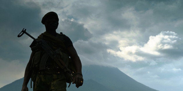 A soldier from the Democratic Republic of Congo regular army (FARDC) stands guard in Kibati near Goma, with the Nyiragongo Vo
