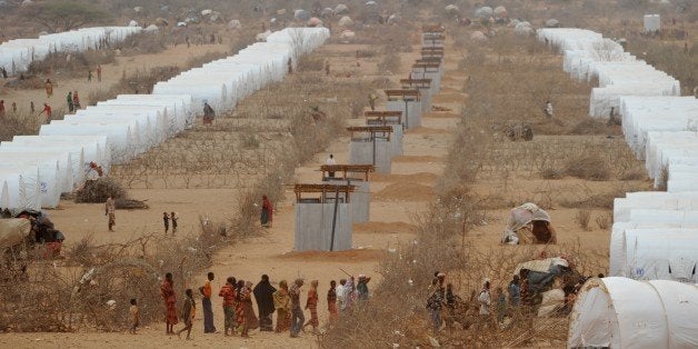 Somali refugees line up to receive aid near a row of tents they now call home at the Kobe refugee camp near the Ethiopia-Somalia border on July 19, 2011. Ethiopian authorities and non-governmental organizations have accomodated almost 25,000 refugees at the camp since it was set up less then three weeks ago. Thousands of Somalis have fled in recent months to neighbouring Ethiopia and Kenya in search of food and water, with many dying along the way, as the region suffers what the UN has described as the worst drought in decades. AFP PHOTO/ROBERTO SCHMIDT (Photo credit should read ROBERTO SCHMIDT/AFP/Getty Images)