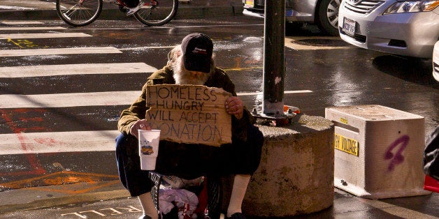 SAN FRANCISCO, CA - DECEMBER 22: A panhandler begs for money at the entrance to Macy's Union Square on December 22, 2012, in San Francisco, California. Despite cold and rainy weather, San Francisco is still a major attraction for tourists during the Christmas holidays. (Photo by George Rose/Getty Images)