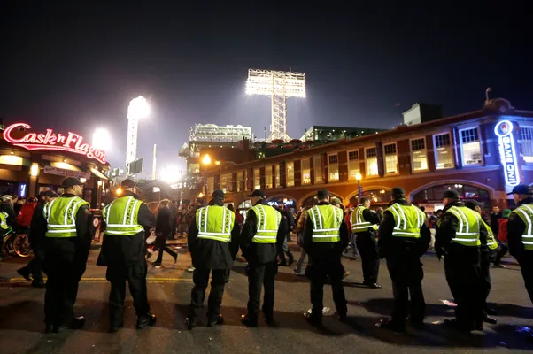 An unidentified man blocks police in riot gear outside Fenway Park in  Boston after the Boston Red Sox swept the St. Louis Cardinals to win the  World Series Wednesday, Oct. 27, 2004. (