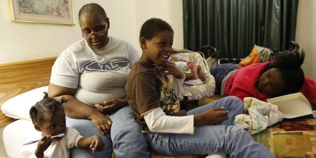 Angelisa Bullock sits with her grandchildren, Julyiah Jackson, 2, from left, Amauri Blackman, 9, and April Jackson, 5 months, as well as her daughter, Dajae Prater, 13, at the Econolodge hotel in Madison, Wisconsin. The family has been greeted by an outpouring of generosity since fleeing Chicago and arriving in the Wisconsin capital on a bus four weeks ago. (Stacey Wescott/Chicago Tribune/MCT via Getty Images)