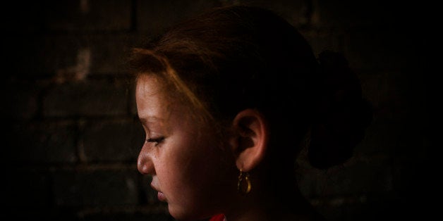 TUZ KHURMATU, IRAQ - AUGUST 25: Sheelan Anwar Omer, 7, continues to cry after a female circumcision was preformed on her. More than 60 percent of women in Kurdish areas of northern Iraq have been circumcised, according to a study conducted this year. In at least one Kurdish territory, 95 percent of women have undergone the practice, which human rights groups call female genital mutilation. Photographed August, 25, 2008 in Tuz Khurmatu, Iraq. (Photo by Andrea Bruce/The Washington Post via Getty Images)