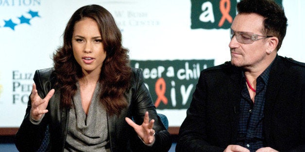 WASHINGTON, DC - DECEMBER 01: Alicia Keys and Bono speak during the 2011 World AIDS Day discussion at George Washington Unive