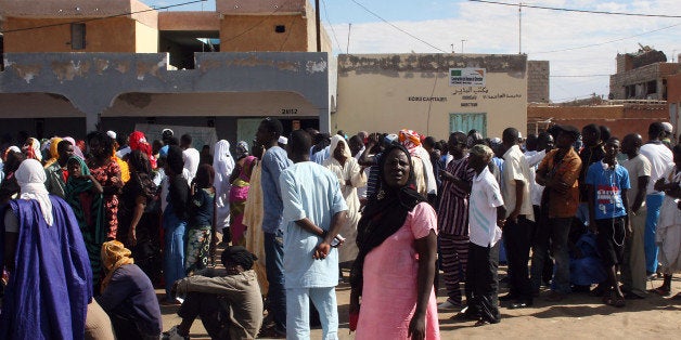 Residents queue up outside the Sebkha polling station in Nouakchott on November 23, 2013. Mauritanians voted Saturday in nationwide elections overshadowed by a widespread boycott of opposition parties, with all eyes on the performance of an Islamist party allowed to take part for the first time. The mainly-Muslim republic, a former French colony on the west coast of the Sahara desert, is seen by the West as strategically important in the fight against Al-Qaeda-linked groups within its own borders, as well in neighbouring Mali and across Africa's Sahel region. AFP PHOTO / Mohamed Ould Elhadj (Photo credit should read Mohamed Ould Elhadj/AFP/Getty Images)