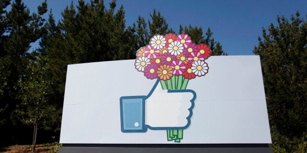 A Facebook 'like' button logo with flowers is seen at the entrance of the Facebook headquarters in Menlo Park, California, on May 11, 2012. Facebook, already assured of becoming one of the most valuable US firms when it goes public later this month, now must convince investors in the next two weeks that it is worth all the hype. Top executives at the world's leading social network have kicked off their all-important road show on Wall Street -- an intense marketing drive ahead of the company's expected trading launch on the tech-heavy Nasdaq on May 18. AFP PHOTO/Kimihiro Hoshino (Photo credit should read KIMIHIRO HOSHINO/AFP/GettyImages)