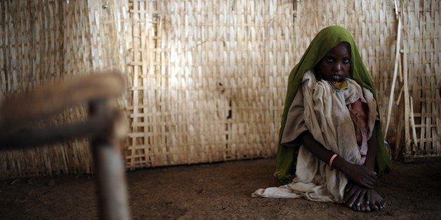 A young woman sits on the floor as she waits to receive medical help at the outpatient unit of a medical center run by Médecins Sans Frontières (MSF) (Doctors without Borders) in the town of Kuyera 04 September 2008. The United Nations appealed in June for 325.2 million dollars (229 million euros) mainly for drought victims after the lack of rain in the main February to April wet season has left at least 75,000 Ethiopian children under age five at risk from malnutrition, according to the UN's Office for the Coordination of Humanitarian Affairs (OCHA) who also asserts that some eight million people need urgent food relief and another 4.6 million need emergency assistance. The MSF staff says that they have diagnosed or treated some 21,000 patients since the end of May. AFP PHOTO/Roberto SCHMIDT (Photo credit should read ROBERTO SCHMIDT/AFP/Getty Images)