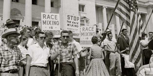 UNITED STATES - CIRCA 1959: people holding signs and American flags protesting the admission of the 'Little Rock Nine' to Central High School. (Photo by Buyenlarge/Getty Images)