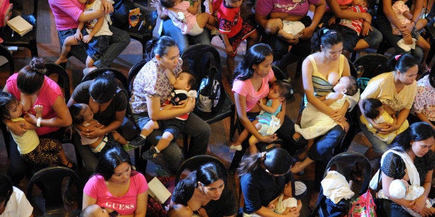 Mothers feed their children during a nationwide simultaneous breastfeeding event in Marikina city, suburban Manila on October 24, 2013. Thousands of mothers across the Philippines simultaneously breastfed their babies in an attempt to break a world record and raise public awarness on human milk consumption. AFP PHOTO/TED ALJIBE (Photo credit should read TED ALJIBE/AFP/Getty Images)