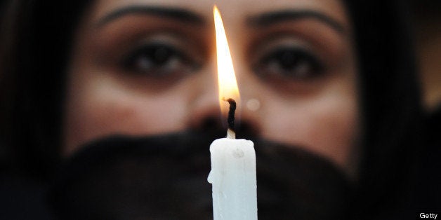 Indian members of a social organisation Our City Our Right holds a candle during a silent protest following the recent gang rape and murder of a 20-year-old college student in Barasat, in Kolkata on June 15, 2013. Activists and social groups in various parts of the state held rallies and protests following the incident. AFP PHOTO/ Dibyangshu SARKAR (Photo credit should read DIBYANGSHU SARKAR/AFP/Getty Images)