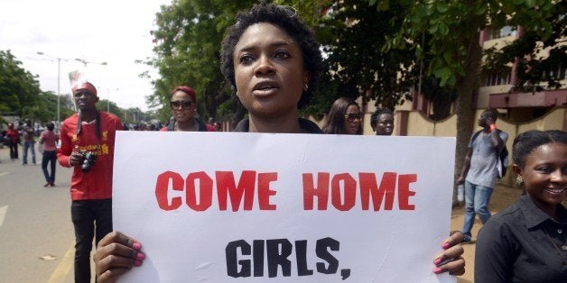 A woman carries placard to press for the release of missing Chibok school girls during a rally by civil society in Lagos on M