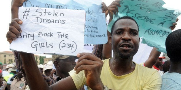 A man carries placard to campaign for the release of schoolgirls kidnapped by Boko Haram Islamists more than two weeks ago during worker's rally in Lagos on May 1, 2014. The mass kidnapping in the Chibok area of northeastern Borno state was one of the most shocking attacks in Boko Haram's five-year extremist uprising, which has killed thousands across the north and centre of the country. AFP PHOTO/PIUS UTOMI EKPEI (Photo credit should read PIUS UTOMI EKPEI/AFP/Getty Images)