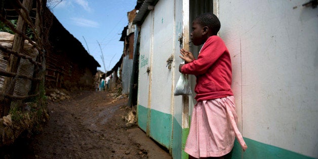 A young school girl emerges from a latrine holding a used Pee Poople bag on June 8, 2012 at Kibera slum, in the Kenyan capital Nairobi, where poor sanitation is endemic and threatens the lives of the local community. A cheap and innovative sanitation solution called 'Pee poople', which consists of a bio-degrable plastic bag pre-loaded with urea is set to change the lives of residents in slums and other informal settlements by digesting human waste quickly and hygienically thus diminishing people's contact with human excrement. Lack of proper toilets has seen numerous slum residents result to defacating outdoors in open fields or river systems greatly increasing the chances of contamination of ground water which leads to poor sanitation and the resulting diseases that claim the life of a child every 12 seconds according to research. AFP PHOTO/Tony KARUMBA (Photo credit should read TONY KARUMBA/AFP/GettyImages)