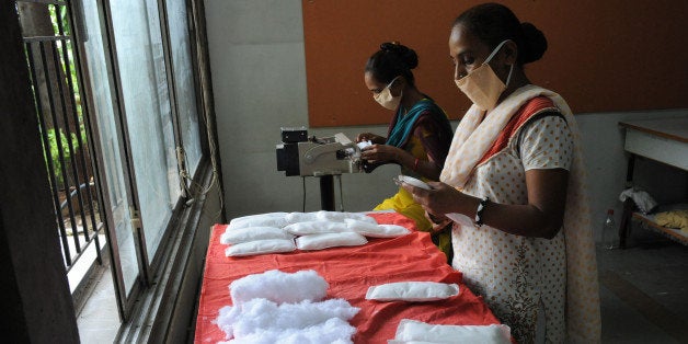 Members of Self Employed Women's Association (SEWA) make low cost sanitary pads at their facility in Ahmedabad on September 3