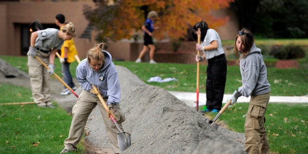 DENVER, CO-- AmeriCorps volunteers, Katy Willis, left, and Lacey Bass, right, both from North Carolina, spread 'crusher fine' material on a new walking path/running trail at Washington Park Saturday morning. 'A large volunteer service effort managed by Volunteers for Outdoor Colorado lead 500 volunteers in repairing and restoring the current Washington Park running trail with new crusher fine surfacing. Half of the registered volunteers are individuals, corporate teams, and families from the community; and half are young adults from the AmeriCorps NCCC program. Additionally, the Park People lead the planting of 25 trees in the Evergreen Hill area of the park to assist with the City's efforts of reforesting.' Andy Cross, The Denver Post (Photo By Andy Cross/The Denver Post via Getty Images)