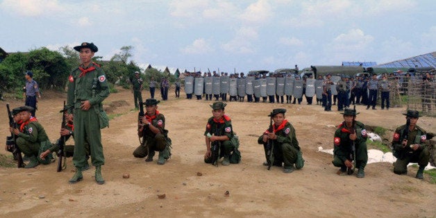 Myanmar security force personnel hold positions following unrest at an Internally Displaced People (IDP) camp for Muslim Rohingyas on the outskirts of Sittwe town in Rakhine State on August 9, 2013. The United Nations has called for dialogue after another violent clash in a camp for dispossessed Rohingya Muslims in western Myanmar, as its human rights envoy toured the strife-torn area. AFP PHOTO / STR (Photo credit should read STR/AFP/Getty Images)