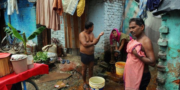 This picture taken on August 8, 2011, shows Indian slum dwellers doing their daily chores in Geeta Colony area of New Delhi. Indian urban slum population is fast expanding and so are cases of diabetes and hypertension among slum dwellers who bid adieu to traditional food habits when they stepping out of their rural set up. Armed with a glucometer and blood pressure monitor, doctors in Indian cities are screening slumdwellers for diabetes and hypertension: diseases spreading at an alarming rate among the urban poor. AFP PHOTO/Prakash SINGH (Photo credit should read PRAKASH SINGH/AFP/Getty Images)