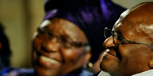 Archbishop Emeritus Desmond Tutu (R) smiles, as his wife Leah (L) smiles at him during the launch of Tutu'sauthorised biography, on October 6, 2011 at St. George's Cathedral, in Cape Town. The biography, titled,'Tutu' was written by veteran journalist, Alister Sparks, and Tutu's daughter, Mpho. The Nobel Peace Prize Laureate, celebrates his 80th birthday on Friday, October 7, 2011. The launch was attended by U2 lead singer, Bono, and a host of other friends, family, and supporters. AFP PHOTO / RODGER BOSCH (Photo credit should read RODGER BOSCH/AFP/Getty Images)