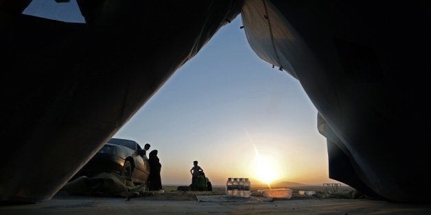 Iraqi families gather at a temporary camp set up to house civilians fleeing violence, in Iraq's northern Nineveh province, in Aski kalak, 40 kms west of the Kurdish autonomous region's capital Arbil, on June 15, 2014. Iraqi security forces have killed 279 'terrorists' in the past 24 hours, as they push back against a major militant offensive, a security spokesman said. AFP PHOTO/KARIM SAHIB (Photo credit should read KARIM SAHIB/AFP/Getty Images)