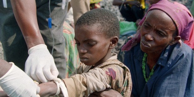 A young Rwandan refugee receives a perfusion, 29 July 1994, by 'MÃ©decins sans FrontiÃ¨res' (MSF, 'Doctors Without Borders') medics as his mother looks on in the Katale refugee camp, some 60kms (40 miles) north of Goma. The medical ad charity 'Doctors Without Borders' was awarded the 1999 Nobel Peace Prize, 15 October 1999, for its 'pioneering humanitarian work on several continents', the Norwegian Nobel Institute announced in Oslo. (Photo credit should read VINCENT AMALVY/AFP/Getty Images)