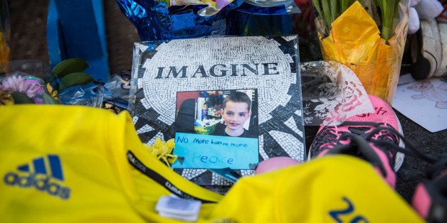 BOSTON, MA - APRIL 20: A photo of Martin Richard, a victim of the Boston Marathon bombing, is displayed near the finish line of the Boston Marathon on April 20, 2014 in Boston, Massachusetts. This year's marathon will be held tomorrow, Monday, April 21; last year two pressure cooker bombs were detonated near the finish line, killing three people and injuring more than 260 others. (Photo by Andrew Burton/Getty Images)