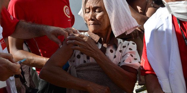 LEYTE, PHILIPPINES - NOVEMBER 18: An old woman is given anti Hepatitis A shots during a medical mission on November 18, 2013 in Tacloban, Leyte, Philippines. Typhoon Haiyan, which ripped through the Philippines on November 9, has been described as one of the most powerful typhoons ever to hit land, leaving thousands dead and hundreds of thousands homeless. Countries all over the world have pledged relief aid to help support those affected by the typhoon, however damage to the airport and roads have made moving the aid into the most affected areas very difficult. With dead bodies left out in the open air and very limited food, water and shelter, health concerns are growing. (Photo by Dondi Tawatao/Getty Images)