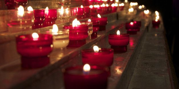 candles flicker in a church in...