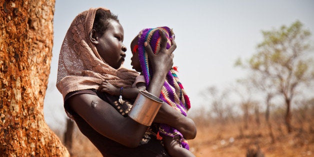 A woman and her child from the Nuba Mountains in Sudan wait outside of the Yida refugee camp registration center in Yida, South Sudan, on April 25, 2012. After an initial attack by SPLA-N rebel forces in South Kordofan, thousands of people from the Nuba Mountains have fled to neighboring Yida to escape the fighting and retaliatory airstrikes by Khartoums Sudan Armed Forces (SAF). AFP / Adriane Ohanesian (Photo credit should read ADRIANE OHANESIAN/AFP/Getty Images)