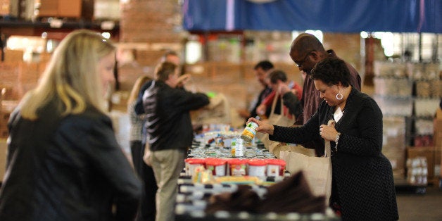 FT. BELVOIR, VA - NOVEMBER 12 Cheryl Janey, R, is among the Northrop Grumman volunteers packing Thanksgiving gift bags for military families at the USO's warehouse at Fort Belvoir on November 12, 2011, in Ft. Belvoir, VA. This holiday season, the Capital Area Food Bank and the USO say they have seen need among military families locally like never before -- as families struggle through multiple deployments and the fallout from the bad economy. The Food Bank took a record 8000 pounds of food in their mobile pantry at Ft. Belvoir earlier this month and the USO's turkey giveaway has risen from 150 families in 2008 to an expected 1400 this year -- a number they have to cap. (photo by Jahi Chikwendiu/The Washington Post via Getty Images)