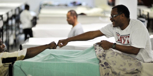 WASHINGTON, DC - NOVEMBER 28 Terrance Coleman, R, a homeless U.S. military veteran, is greeted before bedtime at Central Union Mission, which provides shelter for homeless men, on November 28, 2011, in Washington, DC. Coleman, who is going through Veterans Affairs' drug rehab program, has been homeless four times for a total of about five of the last 10 years. A recent survey provided data about how vets tend to stay on the streets longer than other homeless. The VA (Veterans Affairs) says it is making collaborative efforts with various organizations to meet the VA's stated goal of eliminating the problem by 2014/2015. (photo by Jahi Chikwendiu/The Washington Post via Getty Images)