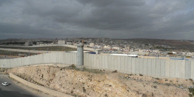 [UNVERIFIED CONTENT] The security wall that separates Israel and Palestine seen here is Ramallah in the distance behind the wall, built by former Israeli Pm Ariel Sharon to try and prevent Palestinian suicide bombers from entering Israel and killing Israelis during the second Palestinian Intifada.