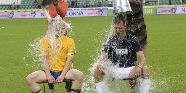 WARSAW, POLAND - AUGUST 31: (SOUTH AFRICA AND POLAND OUT) Piotr Krasko, captain of TVP's team and Kamil Durczok, captain of TVN's team take part in the 'Ice Bucket Challenge aided by Agata Mlynarska and Agnieszka Szulim during the friendly football match between TVP and TVN on August 31, 2014 in Warsaw, Poland. The teams were captained by the leading news presenters of each network while the game was refereed by the former goal keeper of Poland's National Team. All money raised from ticket sales was donated to the Children's Hospital in Lodz for the renovation of the clinic. (Photo by Adam Jagielak/Getty Images Poland/Getty Images)