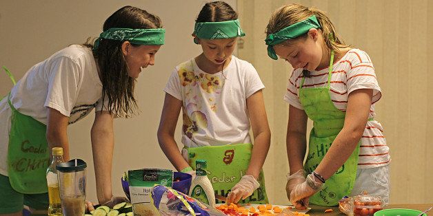 WALTHAM, MA - AUGUST 8: Left to right, Linnea Ericsson Slater, Julienne Crocker and Lindsey Delbanco make salad. ACA Accredited Camp Cedar Hill in Waltham, a Girl Scouts of Eastern Massachusetts camp has a whole session dedicated to cooking. (Photo by Suzanne Kreiter/The Boston Globe via Getty Images)
