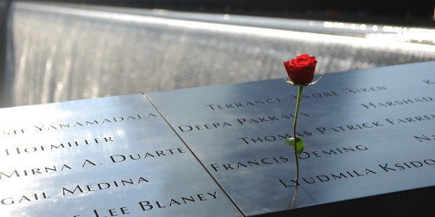 NEW YORK, NY - SEPTEMBER 11: A flower stands in a name at the at the 9/11 Memorial during ceremonies for the twelfth anniversary of the terrorist attacks on lower Manhattan at the World Trade Center site on September 11, 2013 in New York City. The nation is commemorating the anniversary of the 2001 attacks which resulted in the deaths of nearly 3,000 people after two hijacked planes crashed into the World Trade Center, one into the Pentagon in Arlington, Virginia and one crash landed in Shanksville, Pennsylvania. Following the attacks in New York, the former location of the Twin Towers has been turned into the National September 11 Memorial & Museum. (Photo by David Handschuh-Pool/Getty Images)