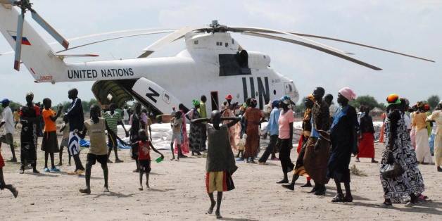 TO GO WITH AFP STORY BY PETER MARTELL Food aid is offloaded from a United Nations helicopter in the southern Sudanese town of Akobo, a remote region in Jonglei state, on August 8, 2009. Thousands have been displaced by a spate of bloody ethnic clashes and supplies are low, with roads closed due to heavy rains and the main river route blocked by hostile neighbouring groups. AFP PHOTO/PETER MARTELL (Photo credit should read PETER MARTELL/AFP/Getty Images)