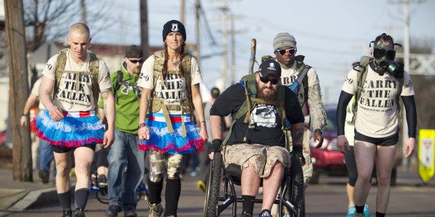 FRAMINGHAM, MA - MARCH 29: A large, often costumed, group, marched the Boston Marathon course on Saturday, March 29, 2014 carrying rucksacks weighing about 50 pounds as part of the Carry the Fallen initiative to raise money and awareness about PTSD and suicides by veterans. (Photo by Dina Rudick/The Boston Globe via Getty Images)