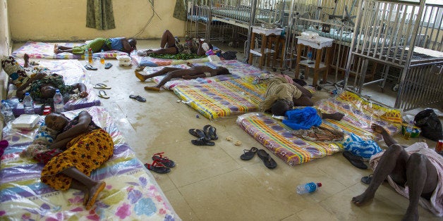 MONROVIA, LIBERIA-SEPTEMBER 20: The scene inside the Redemption Hospital which has become a transfer and holding center to intake Ebola patients located in one of the poorest neighborhoods of Monrovia that locals call 'New Kru Town on Saturday September 20, 2014 in Monrovia, Liberia. Health workers are overwhelm with a constant stream of new patients since the Ebola outbreak. On Friday there were 102 ebola related patients; nine died overnight and Today the hospital has 107 patients. Nine Ebola related deaths occurred overnight Friday but with Saturday admissions they are now holding 107. Liberians have been living under most extreme conditions as the Ebola virus worsens. (Photo by Michel du Cille/The Washington Post via Getty Images)