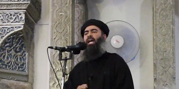 FILE - This file image made from video posted on a militant website Saturday, July 5, 2014, which has been authenticated based on its contents and other AP reporting, purports to show the leader of the Islamic State group, Abu Bakr al-Baghdadi, delivering a sermon at a mosque in Iraq. On Sunday, Nov. 9, 2014, Iraqi officials and state television said al-Baghdadi has been wounded in an airstrike in western Iraq. An Interior Ministry intelligence official told The Associated Press on Sunday that the strike happened early Saturday in the town of Qaim in Iraq's Anbar province. (AP Photo/Militant video, File)