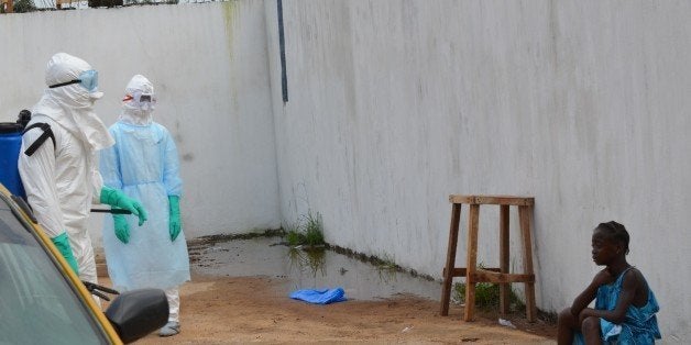 A girl cries outside the 'Island Clinic', a new Ebola treatment centre that opened in Monrovia after the death of her father and her mother by ebola on September 23, 2014. The first members of a team of 165 Cuban doctors and health workers have arrived in Sierra Leone to help the fight against Ebola, a health official said Tuesday. AFP PHOTO / ZOOM DOSSO (Photo credit should read ZOOM DOSSO/AFP/Getty Images)