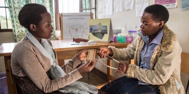 RUBONA, RWANDA - FEBRUARY 05: The young women Tharcille Niyonagira and Joselyne Mukamazimpaka discussing the use of different contraceptives at the Rubona health center on February 05, 2014 in Rubona, Rwanda. Health education on contraception and HIV prevention in Africa. (Photo by Thomas Imo/Photothek via Getty Images)