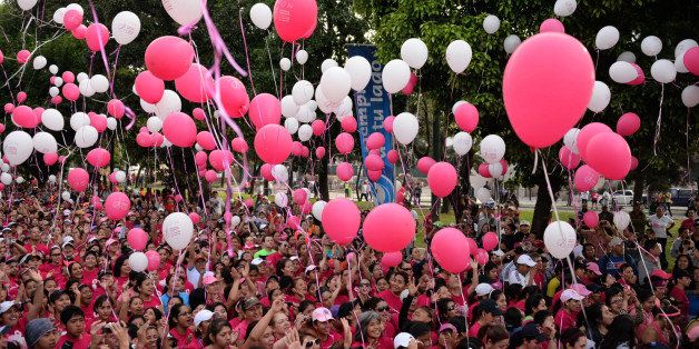Women release balloons at the start of a race and walk against breast cancer in Guatemala City, on March 9, 2014. About 7000 people participated in the event and the funds collected are used to support the National League Against Cancer, in the care and prevention of breast cancer. AFP PHOTO Johan ORDONEZ (Photo credit should read JOHAN ORDONEZ/AFP/Getty Images)