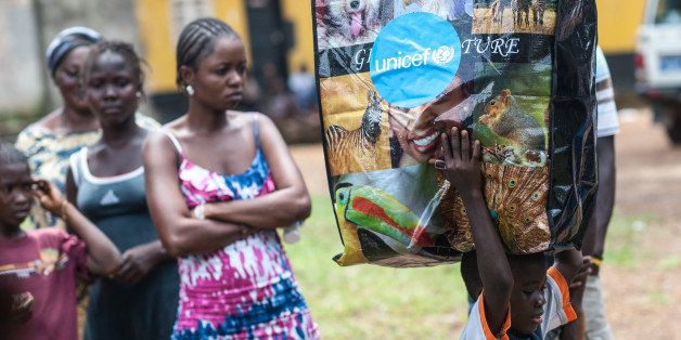 MONROVIA - LIBERIA - OCTOBER 11: Residents of SKD village of the Liberian capital Monrovia receive UNICEF's personal protective kits to help protection from Ebola Virus Disease on October 11, 2014. (Photo by Mohammed Elshamy/Anadolu Agency/Getty Images)