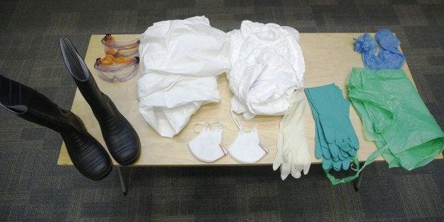 A table of specialist personal protective equipment is displayed during a National Health Service (NHS) volunteer induction and Ebola information session at the Ministry of Health in central London, on October 15, 2014. Almost 4,500 people have died in the Ebola epidemic that broke out in west Africa at the start of the year, according to fresh figures released Wednesday the World Health Organization. AFP PHOTO / LUKE MACGREGOR/POOL (Photo credit should read LUKE MACGREGOR/AFP/Getty Images)