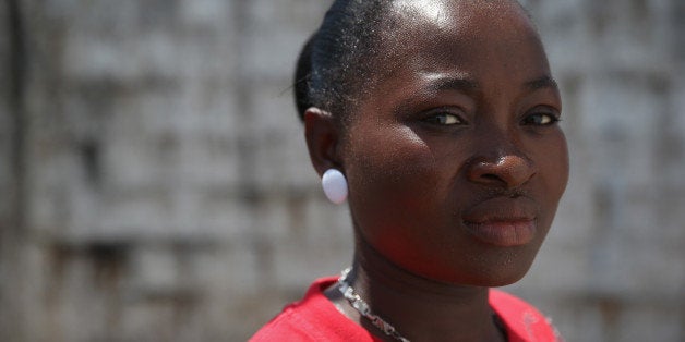PAYNESVILLE, LIBERIA - OCTOBER 16: Ebola survivor Victoria Masah, 28, stands in the low-risk section of the Doctors Without