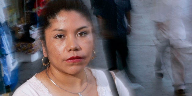 ** ADVANCE FOR SUNDAY, OCT. 30 **Florencia Molina poses for a photo on Alvarado Street in Los Angeles, Sept. 7, 2005. Molina, a victim of human trafficking, became virtually enslaved at a dressmaking shop on the outskirts of Los Angeles where she worked up to 17 hours a day, seven days a week, and lived there, too, without the option of showering or washing her clothes. (AP Photo/Kevork Djansezian)